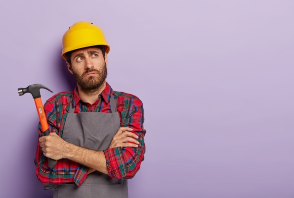 0001_photo-thoughtful-tired-mannual-worker-holds-hammer-keeps-arms-crossed-chest-thinks-about-what-repair-m_1775115307-3f0b1cf836c911ea627d775237b4ffdd.jpg